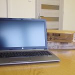 Obrazek przedstawia jeden z zakupionych laptopów z otwartym ekranem ustawiony na biurku.